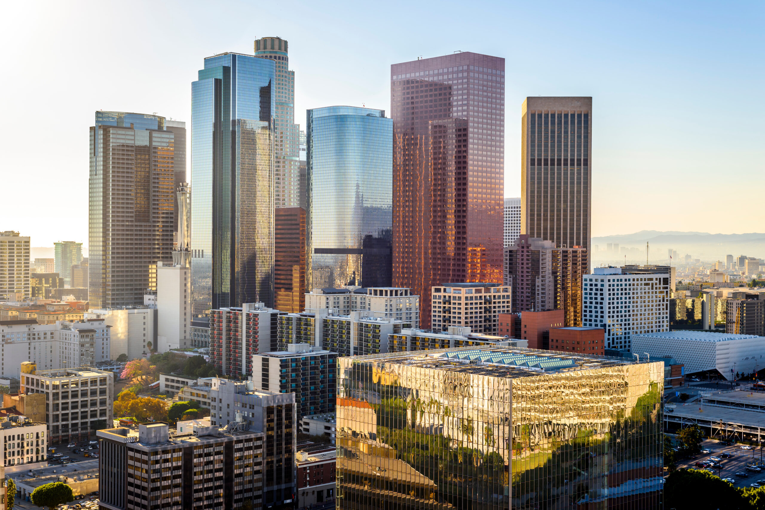 The skyline of downtown Los Angeles glistens in the sun.